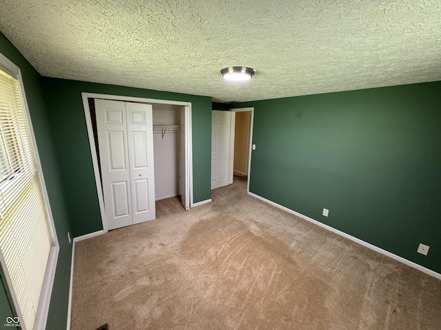 575 Mill Spgs, Coatesville, IN 46121 - unfurnished bedroom with carpet, a closet, a textured ceiling, and baseboards