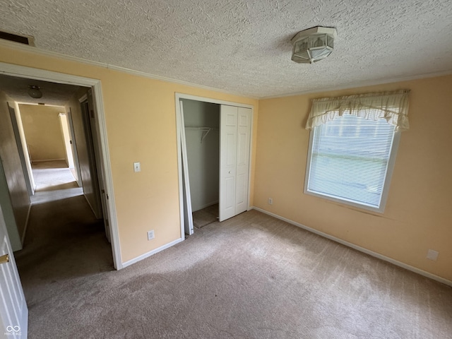 575 Mill Spgs, Coatesville, IN 46121 - unfurnished bedroom featuring a textured ceiling, carpet, a closet, and baseboards