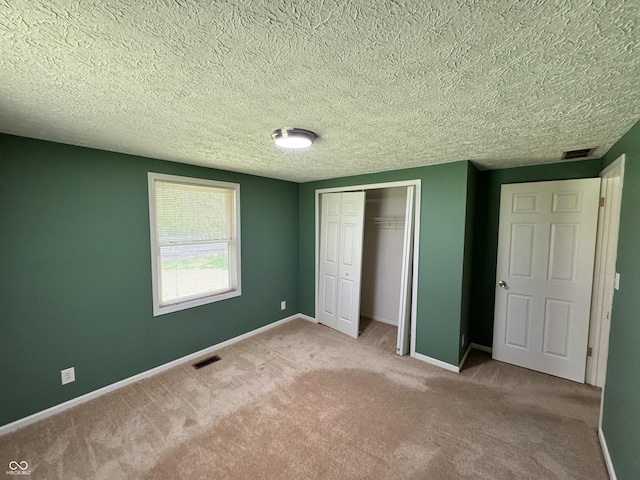 575 Mill Spgs, Coatesville, IN 46121 - unfurnished bedroom featuring carpet, a textured ceiling, a closet, and baseboards