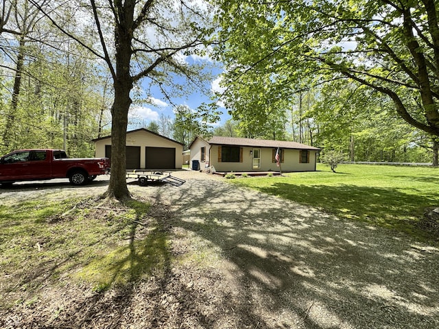 575 Mill Spgs, Coatesville, IN 46121 - view of front of house with a garage, a front yard, and an outdoor structure