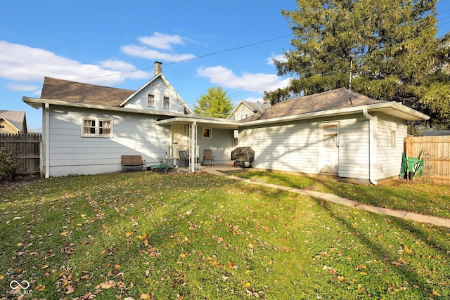205 E Washington St, Roachdale, IN 46172 - back of house with a patio area, fence, and a lawn