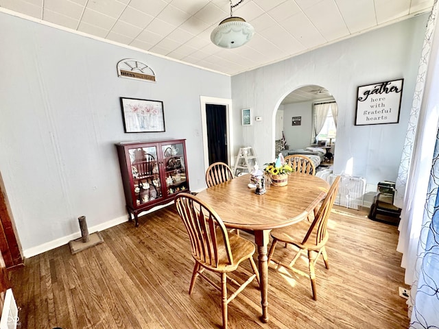 205 E Washington St, Roachdale, IN 46172 - dining space featuring light wood finished floors, ornamental molding, and arched walkways