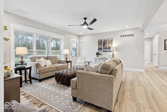 living area featuring baseboards, recessed lighting, light wood finished floors, and ceiling fan