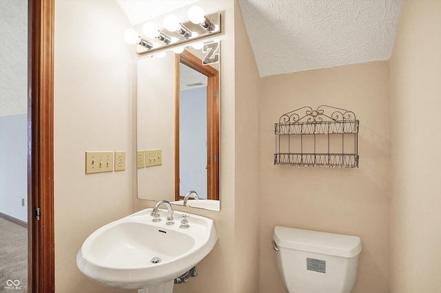 11471 Clarkston Rd, Zionsville, IN 46077 - bathroom featuring a sink, toilet, and a textured ceiling