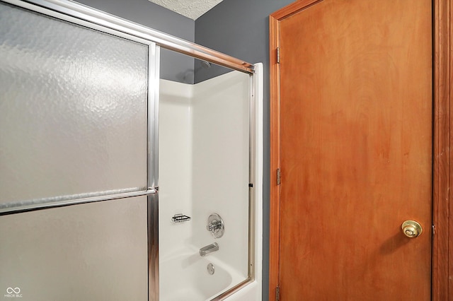11471 Clarkston Rd, Zionsville, IN 46077 - full bath with shower / bath combination with glass door and a textured ceiling