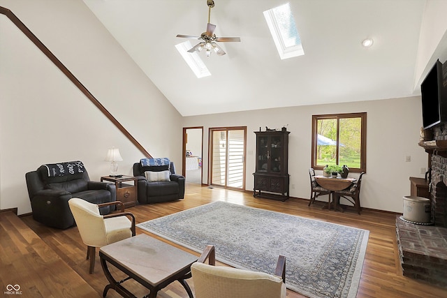 11471 Clarkston Rd, Zionsville, IN 46077 - living room with a skylight, high vaulted ceiling, a fireplace with raised hearth, wood finished floors, and ceiling fan