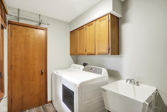 11471 Clarkston Rd, Zionsville, IN 46077 - laundry area with independent washer and dryer, cabinet space, and wood finished floors