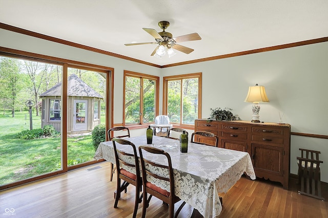 11471 Clarkston Rd, Zionsville, IN 46077 - dining area featuring light wood-type flooring, crown molding, and ceiling fan