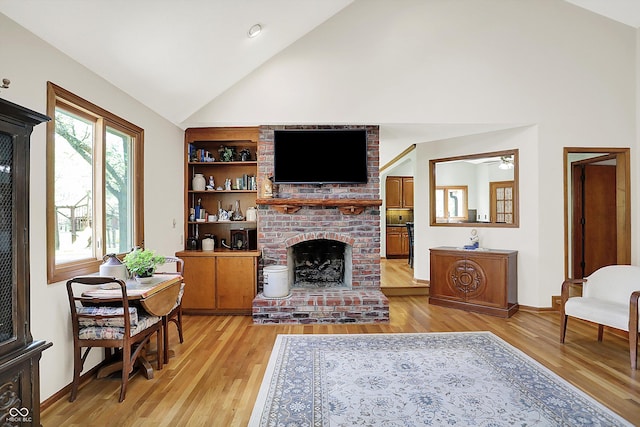 11471 Clarkston Rd, Zionsville, IN 46077 - living area with high vaulted ceiling, light wood-style flooring, a brick fireplace, baseboards, and a ceiling fan