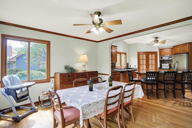 11471 Clarkston Rd, Zionsville, IN 46077 - dining space with ceiling fan, light wood-type flooring, arched walkways, baseboards, and crown molding