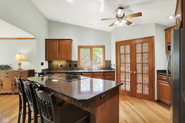 11471 Clarkston Rd, Zionsville, IN 46077 - kitchen featuring freestanding refrigerator, a sink, light wood-style flooring, backsplash, and a kitchen island