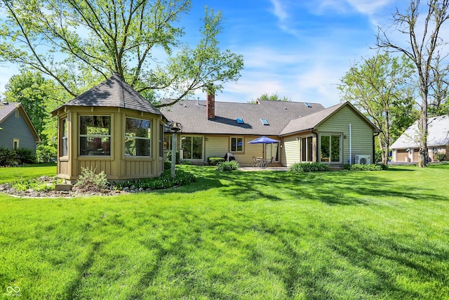 11471 Clarkston Rd, Zionsville, IN 46077 - rear view of property featuring a chimney, board and batten siding, a lawn, and a patio area
