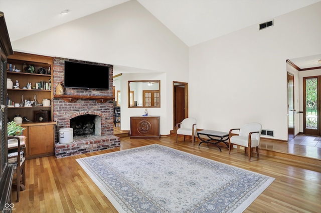 11471 Clarkston Rd, Zionsville, IN 46077 - living room with high vaulted ceiling, light wood finished floors, and a brick fireplace