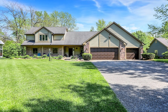 11471 Clarkston Rd, Zionsville, IN 46077 - view of front of house featuring asphalt driveway, an attached garage, a front yard, brick siding, and roof with shingles