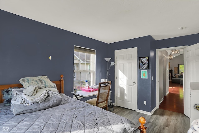 bedroom with wood finished floors and baseboards