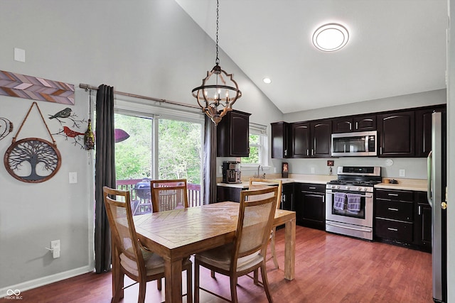 dining room with dark wood-style floors, a chandelier, high vaulted ceiling, baseboards, and recessed lighting