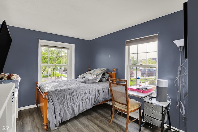 bedroom featuring wood finished floors and baseboards