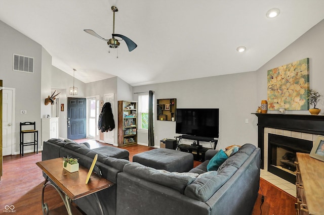 living area featuring ceiling fan, wood finished floors, a tile fireplace, high vaulted ceiling, and recessed lighting