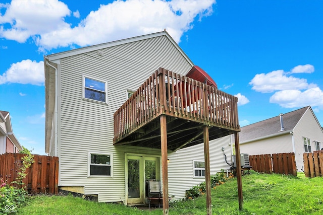 back of house with a wooden deck and central AC