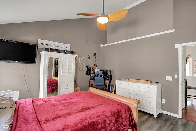 bedroom featuring high vaulted ceiling, dark wood-type flooring, ceiling fan, and baseboards