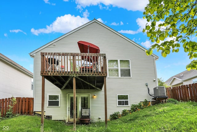 rear view of property with central AC