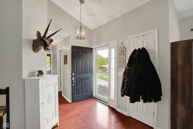 entrance foyer with a chandelier, wood finished floors, high vaulted ceiling, and baseboards