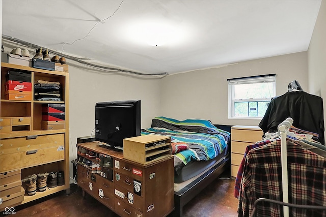 bedroom featuring concrete floors
