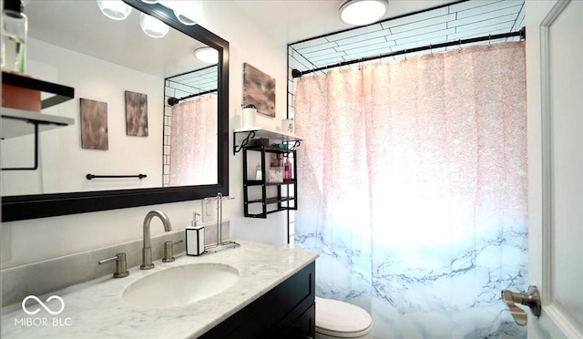 full bathroom featuring toilet, vanity, and curtained shower