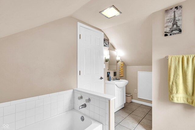 full bath with lofted ceiling, a garden tub, tile patterned floors, and vanity