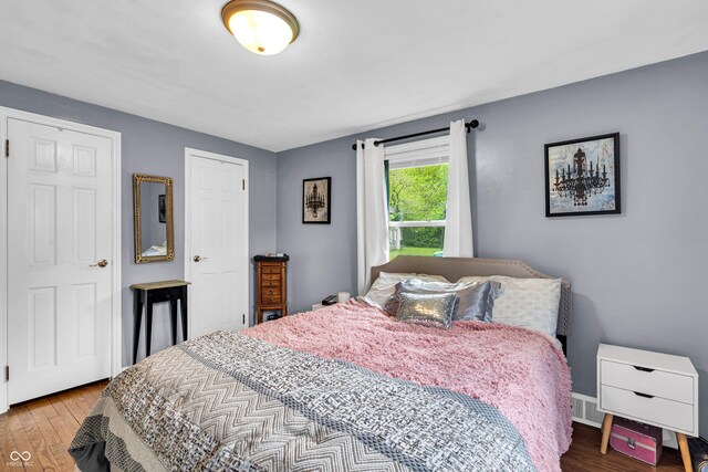 bedroom featuring wood finished floors and baseboards