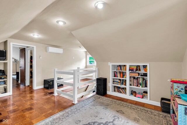bonus room featuring a wall mounted AC, vaulted ceiling, and baseboards