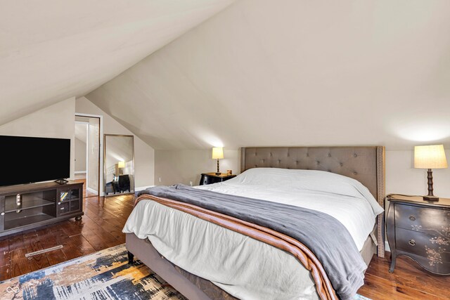 bedroom featuring hardwood / wood-style flooring and vaulted ceiling
