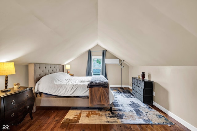 bedroom with hardwood / wood-style floors, baseboards, and lofted ceiling