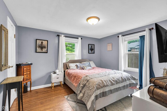 bedroom featuring light wood-type flooring and baseboards