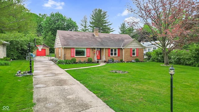 view of front facade with brick siding, an outdoor structure, a chimney, and a front lawn