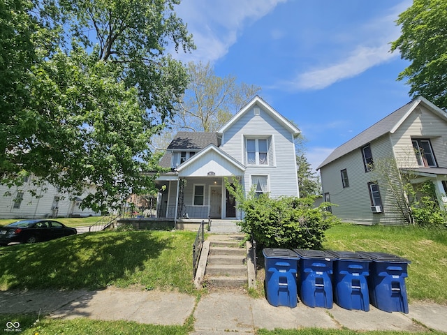 view of front facade with a porch and a front lawn