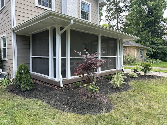 5829 Broadway St, Indianapolis, IN 46220 - view of home's exterior with a sunroom and a lawn