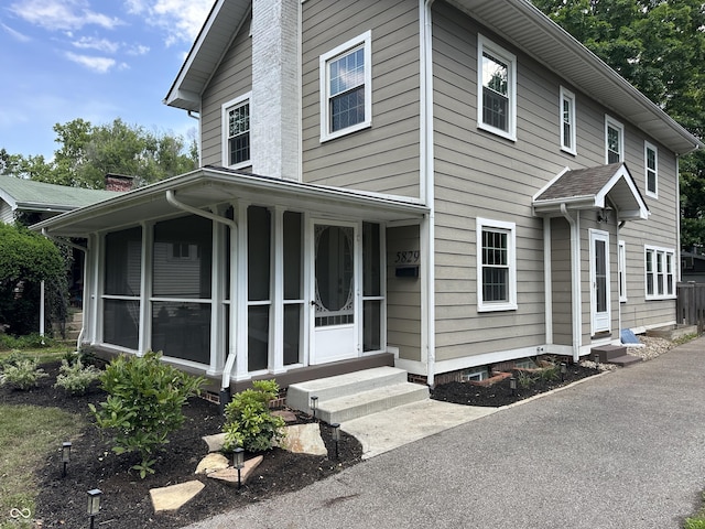 5829 Broadway St, Indianapolis, IN 46220 - view of front of property featuring entry steps, a chimney, and a sunroom