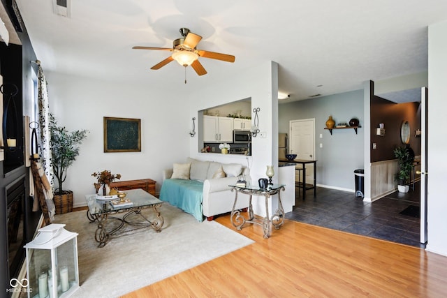 7045 Gavin Dr, Indianapolis, IN 46217 - living area featuring ceiling fan, wood finished floors, and baseboards