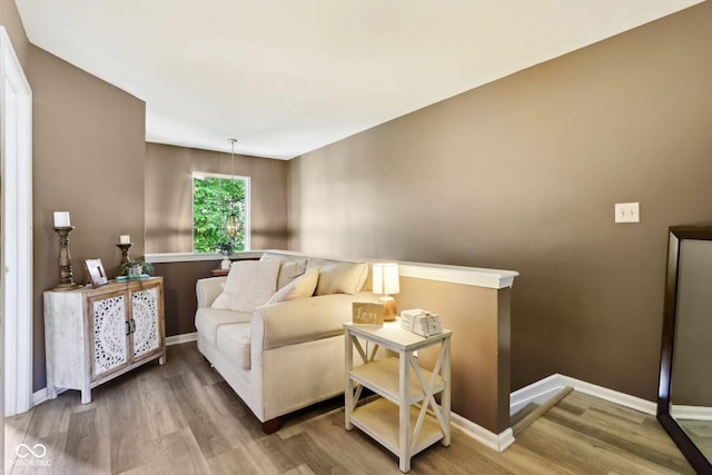 7045 Gavin Dr, Indianapolis, IN 46217 - living area with an upstairs landing, wood finished floors, and baseboards