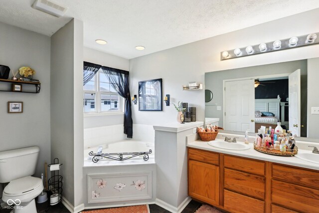 7045 Gavin Dr, Indianapolis, IN 46217 - full bath with toilet, ceiling fan, double vanity, a garden tub, and connected bathroom