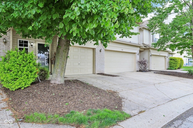 7045 Gavin Dr, Indianapolis, IN 46217 - view of front of property featuring brick siding, driveway, and an attached garage