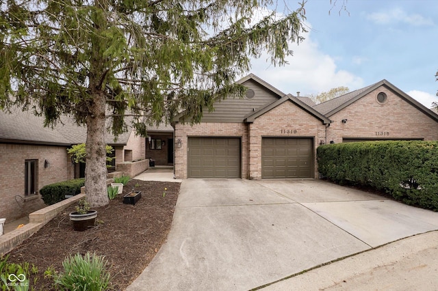 11319 Shoreview Ln, Indianapolis, IN 46236 - ranch-style house featuring brick siding, concrete driveway, and a garage