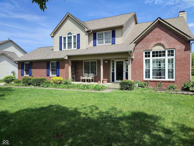 4719 Arabian Run, Indianapolis, IN 46228 - traditional home featuring brick siding, a shingled roof, a front yard, and a chimney
