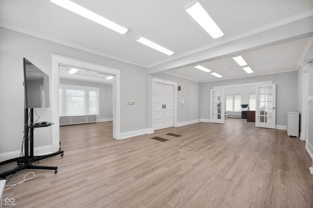 unfurnished living room featuring french doors, radiator, light wood finished floors, baseboards, and crown molding
