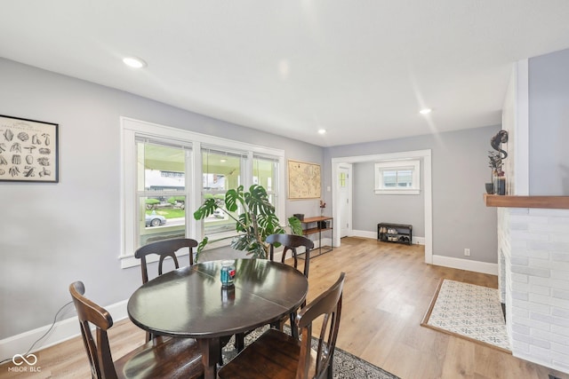 4245 Guilford Ave, Indianapolis, IN 46205 - dining space with baseboards, light wood-style flooring, recessed lighting, and a fireplace
