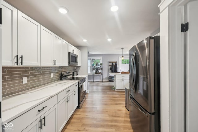 4245 Guilford Ave, Indianapolis, IN 46205 - kitchen with stainless steel appliances, recessed lighting, tasteful backsplash, white cabinetry, and light wood-type flooring