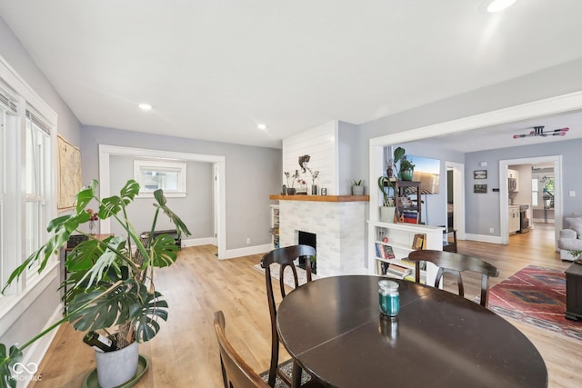 4245 Guilford Ave, Indianapolis, IN 46205 - dining space with wood finished floors, a fireplace, baseboards, and recessed lighting