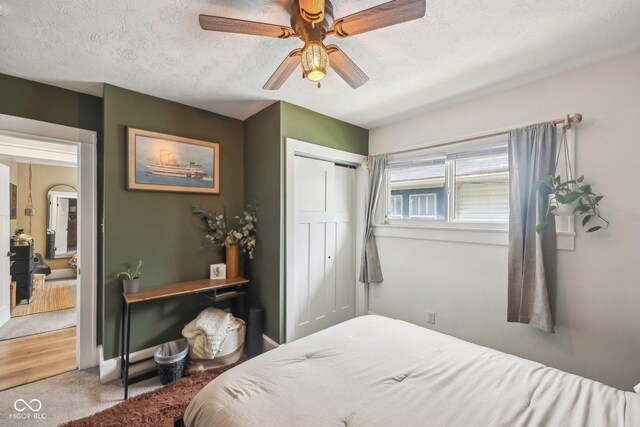 4245 Guilford Ave, Indianapolis, IN 46205 - bedroom with a closet, a ceiling fan, carpet, and a textured ceiling