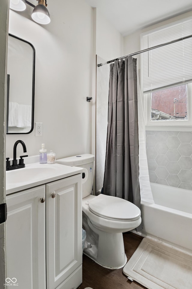 1728 N Delaware St, Indianapolis, IN 46202 - bathroom with toilet, vanity, wood finished floors, and shower / bathtub combination with curtain